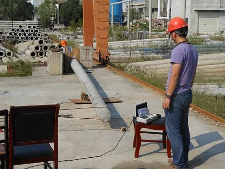 Outdoor cantilever load test arrangement for a tapered circular concrete utility pole