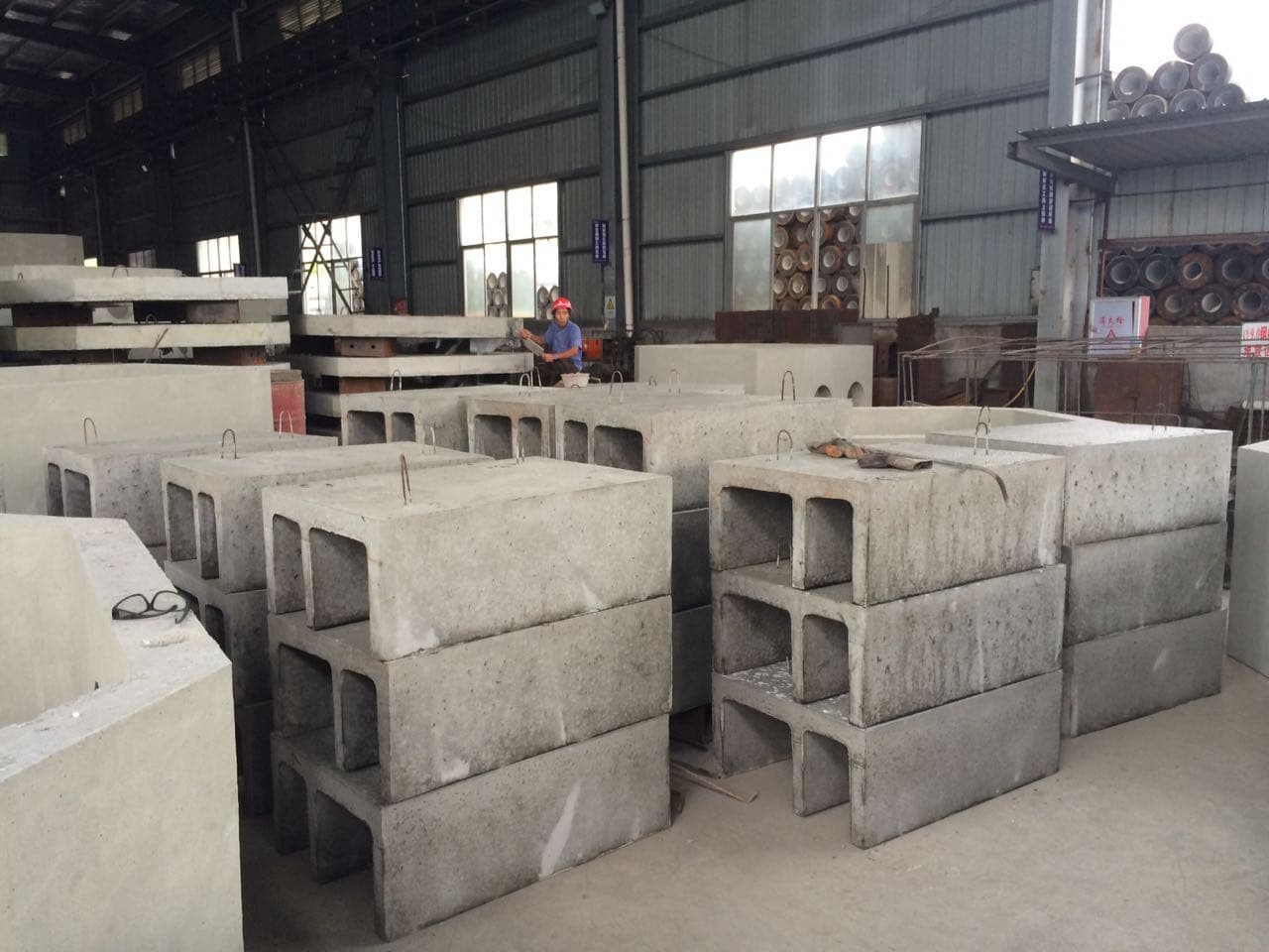 Finished precast concrete cable trough modules stored inside a factory