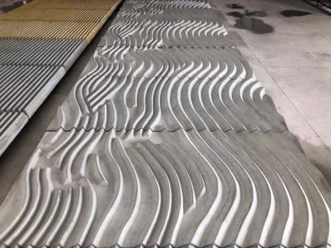 Gray workshop panel or forming reference with a flowing wave-like relief texture