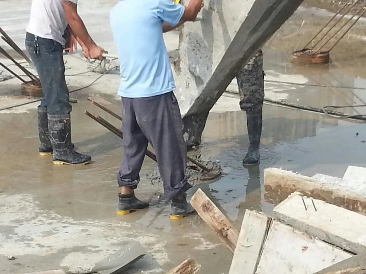 Concrete being placed into a prepared spun-pile core around reinforcement